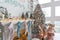 Closeup view of white lving room with big windows and Christmas New year decor,light garland and Christmas tree with presents