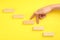 Closeup view of woman imitating stepping up on stairs with her fingers, yellow background. Career promotion concept