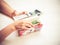 Closeup view of a woman`s hands holding a wallet with money, credit, debit cards for paying, shopping.