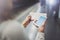 Closeup view of woman on transit platform using smartphone for make photo of train ticket while waiting rail train on