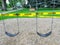 closeup view of yellow caution tape wrapped around swings at a playground due to the covid pandemic