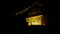 Closeup view of the yellow colored top of an illuminated Buddhist stupa in night with two eyes and prayer flags in Namche Bazar.