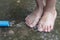 Closeup view of a young child& x27;s feet splashing in water from a r