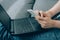 Closeup view of young woman hands using both laptop and smartphone. Social network, online safety and digital lockdown in USA