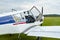 Closeup view of Zlin Z-43 four-seat airplane standing on a grass runway.