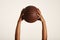 Closeup of a vintage basketball and two muscular dark-skinned hands