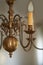 Closeup of a vintage brass chandelier hanging as decoration in a foyer, entrance hall or dinning room during a blackout