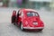 Closeup of vintage red miniature volkswagen bettle in the street