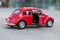 Closeup of vintage red miniature volkswagen bettle in the street