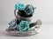 Closeup of a vintage silver-painted watering pot decorated with blue roses