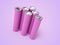 Closeup of violet pile of li-ion batteries. Close up colorful rows of selection of 18650 batteries energy abstract background