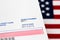 Closeup of voter registration identification card with American flag in background