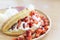 Closeup waffle strawberry ice cream on wood plate, selective focus