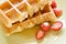 Closeup waffle with syrup and strawberries,breakfast.