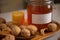 Closeup on walnuts and jar of honey on table