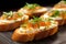 closeup of warm goat cheese bruschetta topped with fresh chives