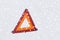 Closeup of warning triangle on snow