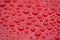 Closeup waterdrops on red ceramic coated paint surface