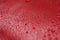 Closeup waterdrops on red ceramic coated paint surface