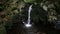 Closeup of a waterfall and stones with green moss