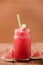 Closeup watermelon juice in glass on wood table with with slices