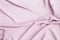 Closeup waving pink fabric background
