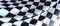 Closeup of a wavy checkered flag under the lights - perfect for wallpapers and backgrounds