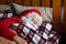 Closeup of a weary Santa Claus sleeping in his bed at the North Pole after his Christmas Eve deliveries