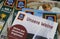 Closeup of weekly printed advertising inserts from german Aldi discounter with focus on catalogue with german wine selection