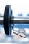 Closeup weight plate fixed on barbell in gym