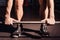 Closeup of weightlifter clapping hands before barbell workout at the gym