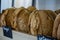 Closeup of wheat bread loaves stacked on the market st