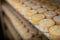 Closeup of wheels of sheep cheese on shelves in ripening room