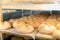 Closeup of wheels of sheep cheese on shelves in ripening room