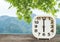 Closeup white clock for decorate in 6 o`clock on blurred mountain view background
