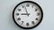 Closeup of White Clock Face on white wall clock, arrows show 21 or 09