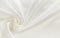 Closeup of white draped satin fabric