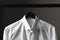 Closeup of a white dress shirt on a black hanger