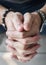 Closeup of white hands in praying gesture