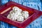 Closeup of white meringue on a red square saucer