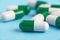 Closeup of white pills on a blue background. Heap of pills - medical background