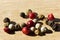 Closeup of white, red and black peppercorn on a table