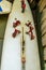 Closeup of a a white surfboard with red straps, surfing gear, equipment of a popular water sport