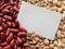 Closeup of White tag on Raw Red Beans, lentils and chickpeas Background