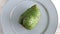 Closeup of whole green soursop graviola, exotic, tropical fruit Guanabana on plate