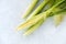 Closeup of Whole Unpeeled and Peeled Baby Corn with Leaves