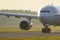 Closeup of wide-body passenger plane taxiing on the runway, during sunset. Airplane turns on runway