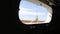 Closeup of a window and deck of a wooden antique Sail boat navigating in the ocean sunny day showing the wooden parts and