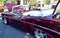 Closeup of a Wine Colored 1965 Classic C-10 Chevy Pickup Truck and white top with hood up