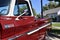 Closeup of a Wine Colored 1965 Classic C-10 Chevy Pickup Truck and white top with hood up